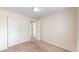A well-lit bedroom featuring neutral walls, carpet flooring, and a closet with sliding doors at 4164 E 135Th Pl, Thornton, CO 80241