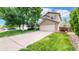 Charming two-story home with a brick-accented garage and a well-manicured front yard at 4164 E 135Th Pl, Thornton, CO 80241