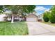 Charming two-story home with a brick-accented garage and a well-manicured front yard at 4164 E 135Th Pl, Thornton, CO 80241
