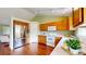 Well-lit kitchen with white appliances, wood cabinets, and stainless steel refrigerator at 4164 E 135Th Pl, Thornton, CO 80241