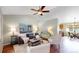 Bright living room with hardwood floors, ceiling fan, and modern furnishings at 4164 E 135Th Pl, Thornton, CO 80241