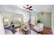 Bright living room with hardwood floors, ceiling fan, and modern furnishings at 4164 E 135Th Pl, Thornton, CO 80241