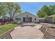 Landscaped backyard featuring a deck, covered patio and well-manicured lawn at 1367 Teller St, Lakewood, CO 80214