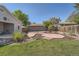 Landscaped backyard with a deck, lawn, and decorative rock features at 1367 Teller St, Lakewood, CO 80214