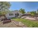 Spacious backyard with a deck, lawn, and landscaping features at 1367 Teller St, Lakewood, CO 80214