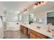 Bright bathroom featuring a soaking tub, double sinks, and neutral finishes at 1367 Teller St, Lakewood, CO 80214
