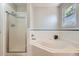 Bathroom featuring a shower, soaking tub, and window at 1367 Teller St, Lakewood, CO 80214