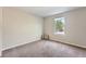 Bedroom with neutral paint, plush carpet, and a bright window at 1367 Teller St, Lakewood, CO 80214