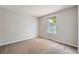 Bright bedroom with neutral walls, carpeted floor, and window providing natural light at 1367 Teller St, Lakewood, CO 80214