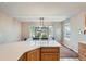 Open dining area features a modern light fixture and a large window with backyard views at 1367 Teller St, Lakewood, CO 80214
