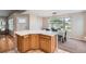 Modern kitchen with light countertops, wood cabinets, and a dining area with large windows at 1367 Teller St, Lakewood, CO 80214