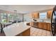 Spacious kitchen with stone countertops, ample cabinet space, and a dining area with natural light at 1367 Teller St, Lakewood, CO 80214