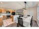 Open kitchen and dining area featuring stainless steel appliances, wood cabinets, and eat-in counter at 1367 Teller St, Lakewood, CO 80214