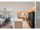 Well-lit kitchen featuring an island with light countertops and stainless steel appliances at 1367 Teller St, Lakewood, CO 80214
