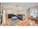 Bright living room features hardwood floors, comfortable seating, and a cozy fireplace at 1367 Teller St, Lakewood, CO 80214
