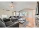 Bright living room features hardwood floors, comfortable seating, and a neutral color palette at 1367 Teller St, Lakewood, CO 80214