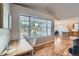 Open-concept living area offers hardwood floors, natural light, and a view of the outdoor patio at 1367 Teller St, Lakewood, CO 80214