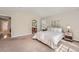 Spacious main bedroom showcasing plush carpet, neutral paint, and access to the en-suite bathroom at 1367 Teller St, Lakewood, CO 80214
