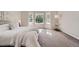 Comfortable main bedroom featuring plush carpet, a bay window, and neutral paint at 1367 Teller St, Lakewood, CO 80214