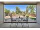 Covered patio with outdoor furniture overlooking a beautifully landscaped backyard at 1367 Teller St, Lakewood, CO 80214