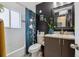 Cozy bathroom featuring a patterned shower curtain, dark vanity, and black wallpaper at 2870 Pontiac St, Denver, CO 80207