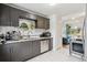Contemporary kitchen with stainless steel appliances, granite countertops, and sleek, gray cabinets at 2870 Pontiac St, Denver, CO 80207