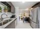 Well-equipped kitchen featuring stainless steel appliances, granite countertops, and an open layout at 2870 Pontiac St, Denver, CO 80207