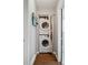 Convenient laundry area with stacked washer and dryer and hardwood flooring at 2870 Pontiac St, Denver, CO 80207
