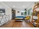Sunlit living area showcasing hardwood floors, comfortable seating, and an inviting atmosphere at 2870 Pontiac St, Denver, CO 80207