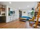 Bright living room featuring hardwood floors, natural light, and an open layout, adjacent to the kitchen at 2870 Pontiac St, Denver, CO 80207
