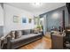 Comfortable living room with hardwood floors, a large gray sofa, and natural light at 2870 Pontiac St, Denver, CO 80207