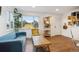 Inviting living room with hardwood floors, stylish decor, ample natural light, and a view of the entry at 2870 Pontiac St, Denver, CO 80207