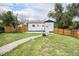 Cozy backyard includes well-maintained lawn, wood fence, white door to back of house, and gravel walkway at 2 S Knox Ct, Denver, CO 80219
