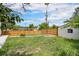 A large, grassy backyard is surrounded by a wood fence and some trees at 2 S Knox Ct, Denver, CO 80219