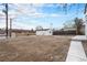 A spacious backyard with a mix of gravel and dirt, offering possibilities for outdoor activities at 2 S Knox Ct, Denver, CO 80219