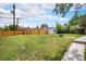 Spacious backyard boasts a well-maintained lawn, wood fence, storage shed, and concrete patio at 2 S Knox Ct, Denver, CO 80219
