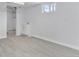 Spacious basement area featuring tile flooring, natural light from the window, and a utility sink at 2 S Knox Ct, Denver, CO 80219