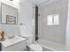 Modern bathroom featuring a sleek vanity, toilet, and a tiled shower-tub combo with contemporary fixtures at 2 S Knox Ct, Denver, CO 80219