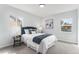Bright bedroom featuring a blue headboard, carpeted floors, and two windows for natural light at 2 S Knox Ct, Denver, CO 80219