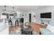 Open-concept living area with kitchen view, stylish decor, and hardwood flooring at 2 S Knox Ct, Denver, CO 80219