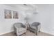 A cozy living room area, furnished with matching upholstered chairs and decorative wall art at 2 S Knox Ct, Denver, CO 80219