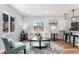 Cozy living room featuring neutral furniture, a large window, and modern decor at 2 S Knox Ct, Denver, CO 80219