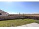 Large backyard with a wood fence, offering privacy and space for outdoor activities at 975 Alta St, Lochbuie, CO 80603