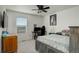 Comfortable bedroom with a desk, ceiling fan, and a bright window at 975 Alta St, Lochbuie, CO 80603