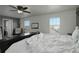 Spacious bedroom with two windows, a ceiling fan, and plush bedding at 975 Alta St, Lochbuie, CO 80603