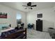 Bright bedroom with ceiling fan, window, and desk area at 975 Alta St, Lochbuie, CO 80603