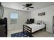 Bright bedroom with a cozy single bed, desk, ceiling fan and colorful decorative LED lighting at 975 Alta St, Lochbuie, CO 80603