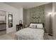 Cozy bedroom featuring an accent wall with vine decor at 975 Alta St, Lochbuie, CO 80603
