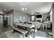 Open-concept dining area featuring a large table with bench seating and stylish decor at 975 Alta St, Lochbuie, CO 80603