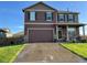 Charming two-story home with a well-manicured lawn and a two-car garage at 975 Alta St, Lochbuie, CO 80603
